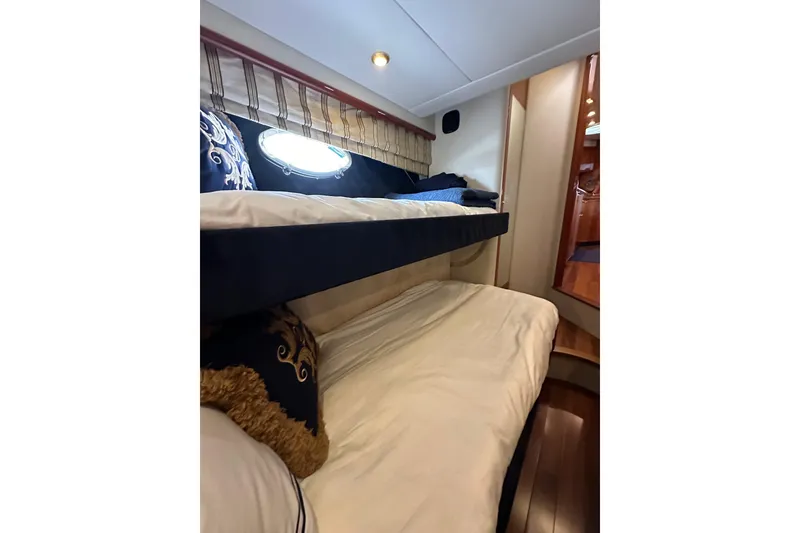 Slide: The Image of Interior cabin of 2000 Sunseeker Predator 60 yacht with bunk beds and elegant decor. - 61