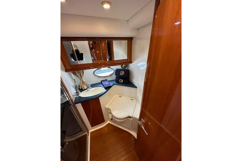 Slide: The Image of Luxurious bathroom in 2000 Sunseeker Predator 60 yacht with wood accents and modern fixtures. - 66