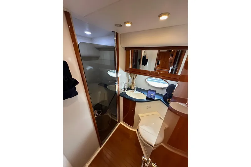 Slide: The Image of Luxurious bathroom in 2000 Sunseeker Predator 60 yacht with modern fixtures and wood accents. - 67