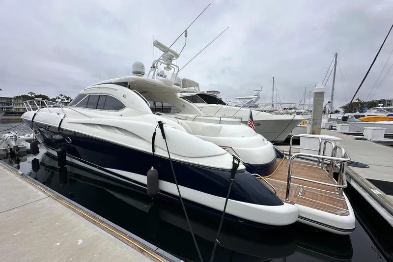Slide: The Image of Sunseeker Predator 60 yacht, 2000 model, docked at marina under cloudy sky. - 7