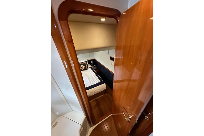 Slide: The Image of Interior cabin of 2000 Sunseeker Predator 60 yacht with wooden door and cozy bed. - 71