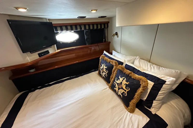 Slide: The Image of Luxurious cabin interior of 2000 Sunseeker Predator 60 yacht with elegant bedding and TV. - 75