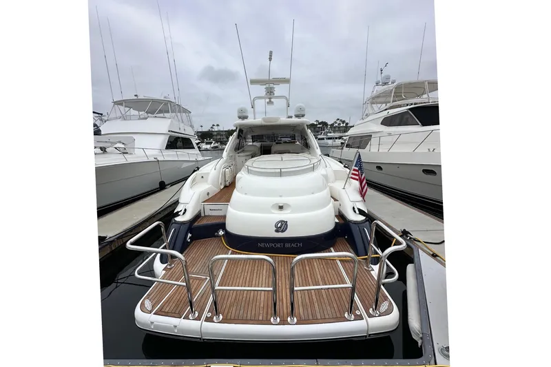 Slide: The Image of Sunseeker Predator 60 yacht, 2000 model, docked at marina with American flag. - 8