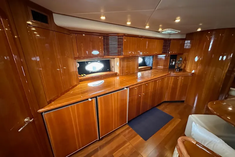 Slide: The Image of Luxurious wooden interior of a 2000 Sunseeker Predator 60 yacht kitchen area. - 80