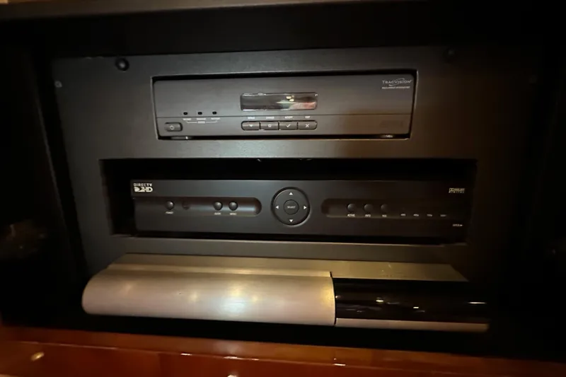Slide: The Image of Entertainment system in a 2000 Sunseeker Predator 60 yacht, featuring satellite and audio equipment. - 83