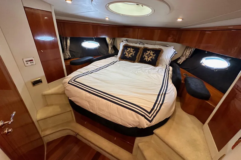 Slide: The Image of Luxurious cabin interior of 2000 Sunseeker Predator 60 yacht with elegant bedding and wood finishes. - 99