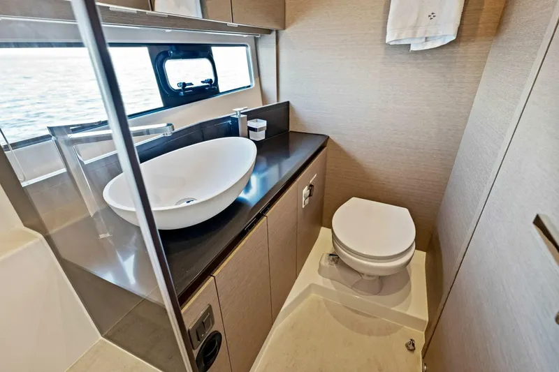 Slide: The Image of Luxurious bathroom in 2023 Prestige 460 Flybridge yacht with modern sink and toilet. - 29
