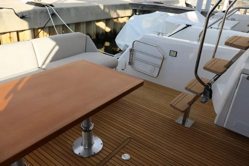 Slide: The Image of Luxury yacht deck with wooden table and stairs, Prestige 460, 2023 model. - 41