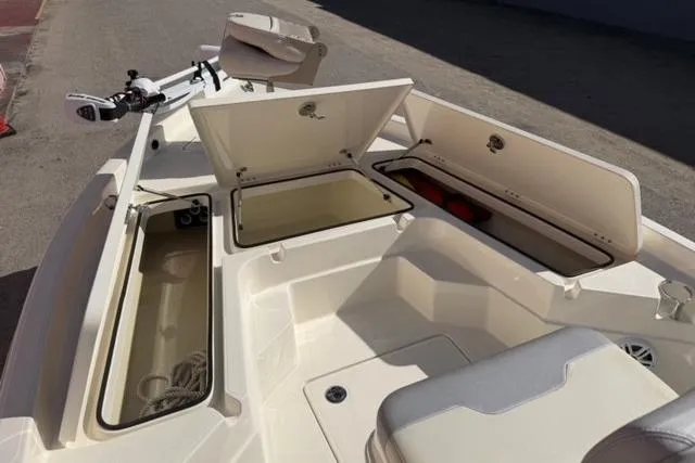 Slide: The Image of 2016 Skeeter SX210 boat interior with open storage compartments and seating. - 10