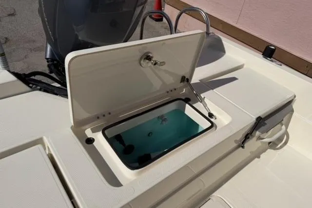 Slide: The Image of 2016 Skeeter SX210 boat livewell with open lid, showcasing interior features. - 12