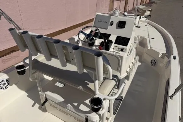 Slide: The Image of 2016 Skeeter SX210 boat interior with steering console and rod holders. - 13