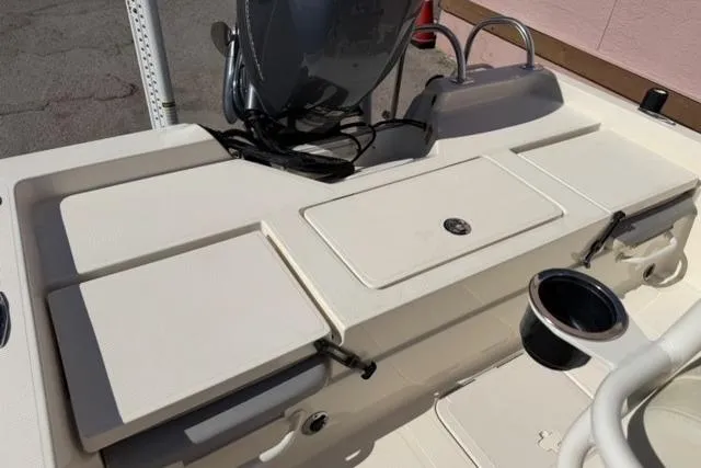 Slide: The Image of 2016 Skeeter SX210 boat deck with storage compartments and cup holder. - 15