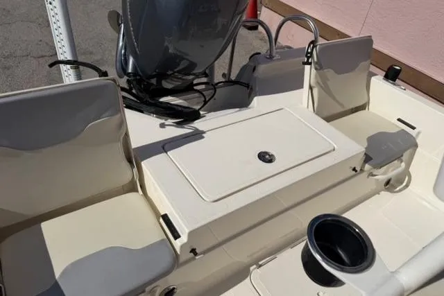 Slide: The Image of 2016 Skeeter SX210 boat interior with seating and storage compartments. - 9