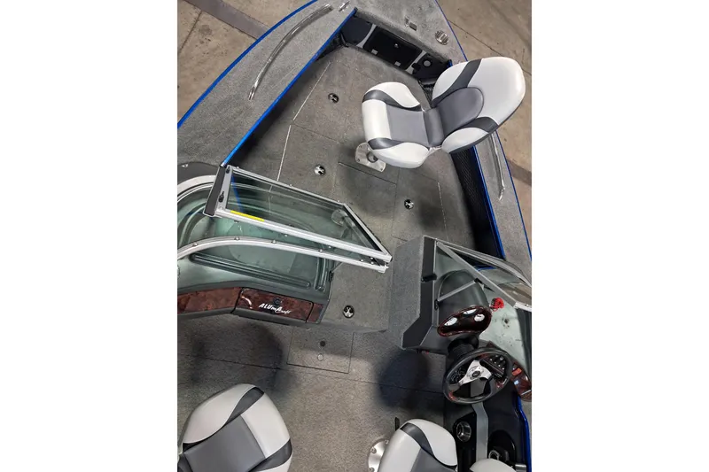 Slide: The Image of 2015 Alumacraft Trophy 175 boat interior with seating and steering wheel. - 12
