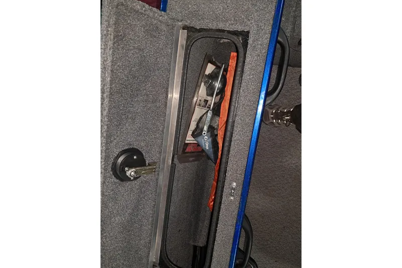 Slide: The Image of 2015 Alumacraft Trophy 175 storage compartment with fishing gear inside. - 14