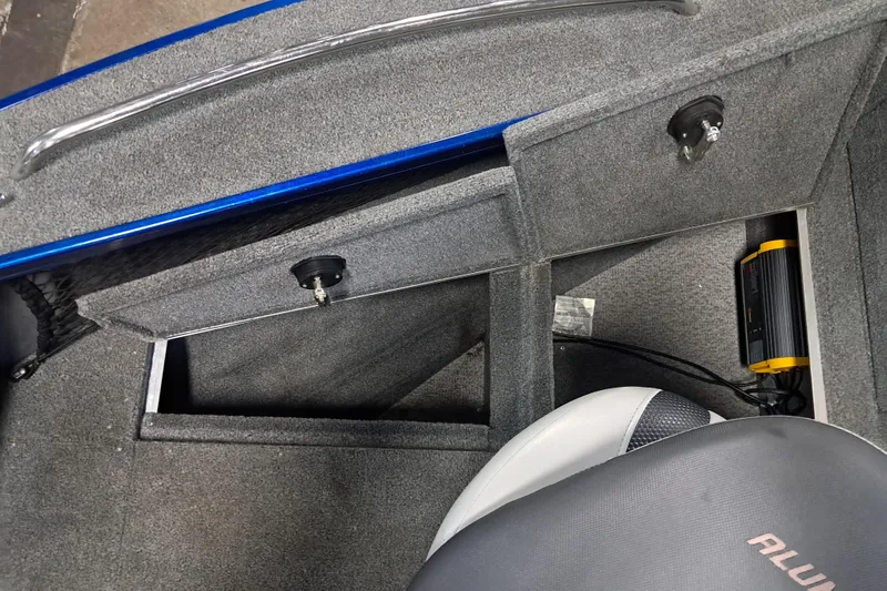 Slide: The Image of 2015 Alumacraft Trophy 175 boat interior with storage compartments and seat. - 17