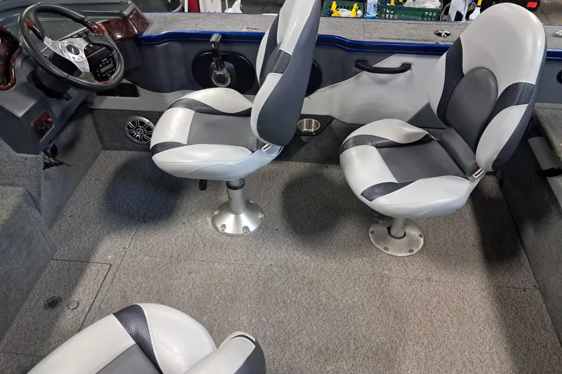 Slide: The Image of 2015 Alumacraft Trophy 175 boat interior with gray seating and steering wheel. - 18