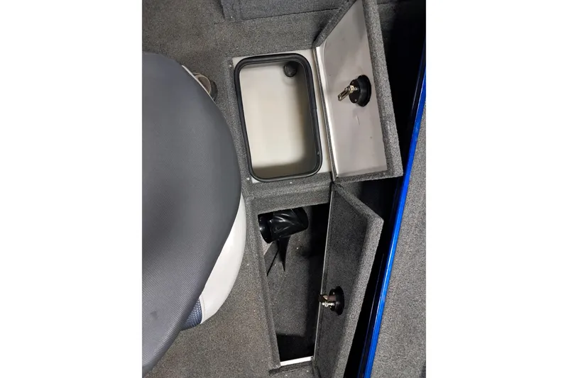 Slide: The Image of 2015 Alumacraft Trophy 175 boat interior storage compartments with open lids. - 20