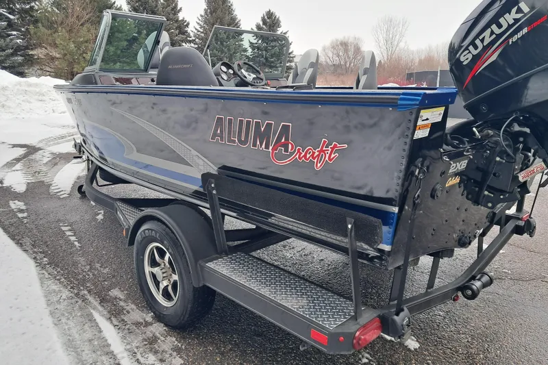 Slide: The Image of 2015 Alumacraft Trophy 175 boat with Suzuki outboard motor on a trailer. - 3