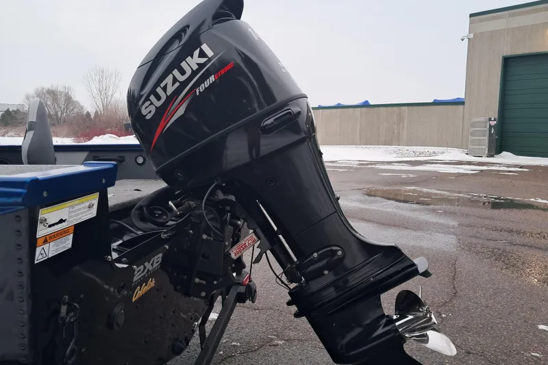 Slide: The Image of 2015 Alumacraft Trophy 175 with Suzuki outboard motor in snowy outdoor setting. - 4