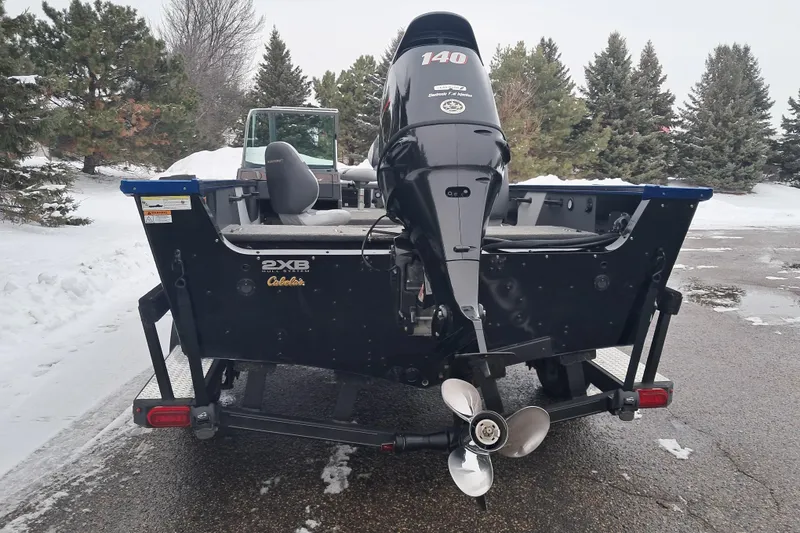 Slide: The Image of 2015 Alumacraft Trophy 175 boat with outboard motor in snowy landscape. - 5