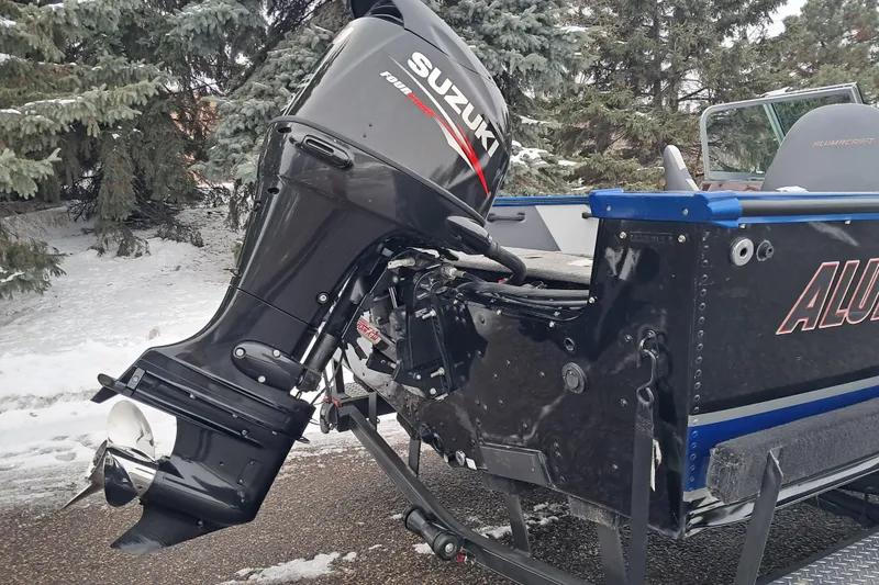 Slide: The Image of 2015 Alumacraft Trophy 175 boat with Suzuki outboard motor in snowy setting. - 6
