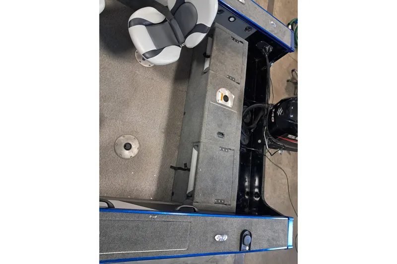 Slide: The Image of 2015 Alumacraft Trophy 175 boat interior with seating and storage compartments. - 7