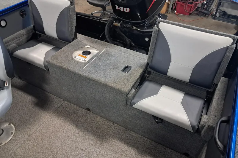 Slide: The Image of 2015 Alumacraft Trophy 175 boat interior with gray seating and motor. - 8