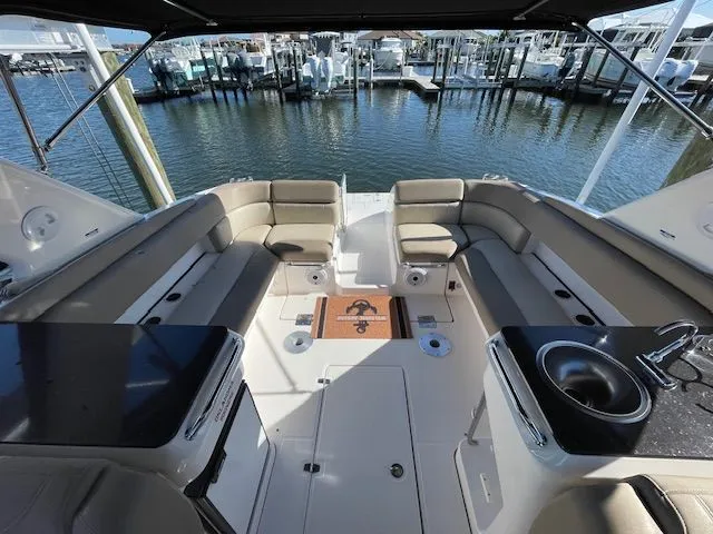 Slide: The Image of Interior of a 2014 Regal 3550 Cuddy yacht with seating area and sink. - 17