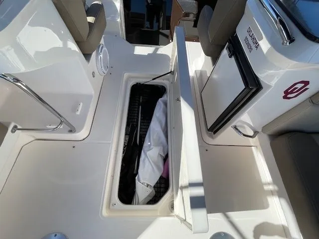 Slide: The Image of 2014 Regal 3550 Cuddy with open storage compartment and fridge. - 18