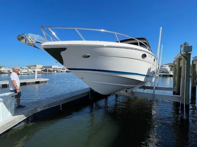 Slide: The Image of 2014 Regal 3550 Cuddy on boat lift at dock. - 2
