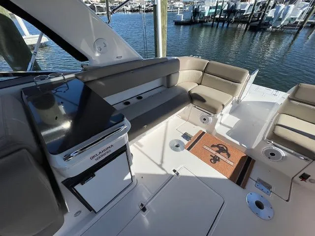 Slide: The Image of Interior of a 2014 Regal 3550 Cuddy boat with seating area. - 21