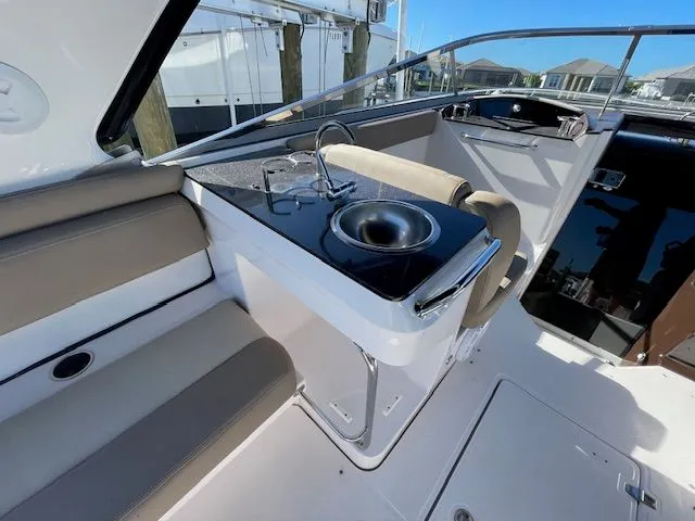 Slide: The Image of Interior of 2014 Regal 3550 Cuddy with sink and seating area. - 23