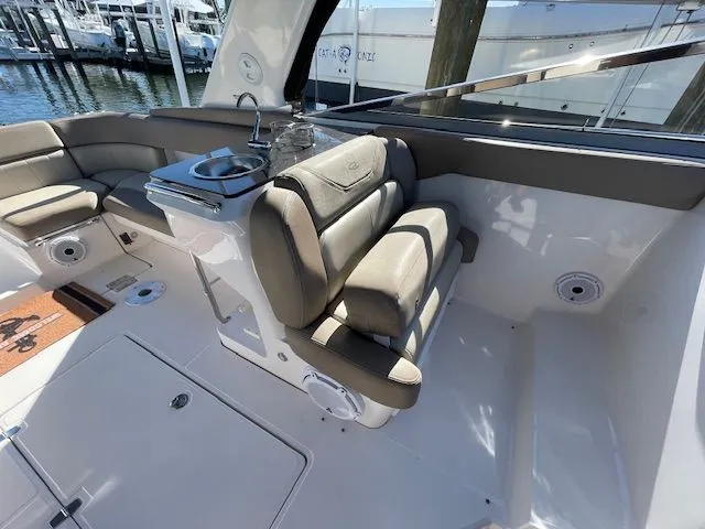 Slide: The Image of Interior of a 2014 Regal 3550 Cuddy boat with seating area. - 25