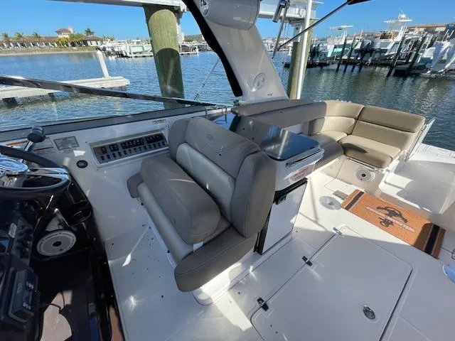 Slide: The Image of 2014 Regal 3550 Cuddy boat interior with seating and controls. - 26