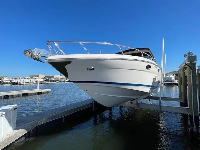 Slide: The Image of 2014 Regal 3550 Cuddy boat docked under clear blue sky. - 3
