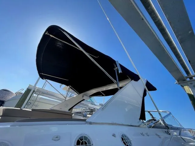 Slide: The Image of 2014 Regal 3550 Cuddy with sunshade, blue sky. - 4