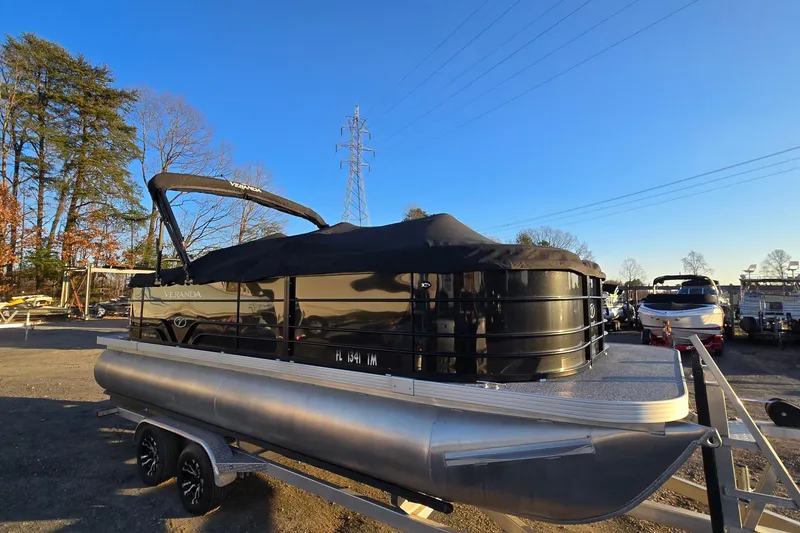 Slide: The Image of 2023 Veranda Vista View 20RC pontoon boat on trailer, covered, in outdoor setting. - 1