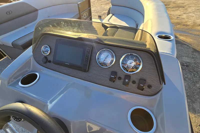 Slide: The Image of 2023 Veranda Vista View 20RC boat dashboard with gauges and controls. - 16