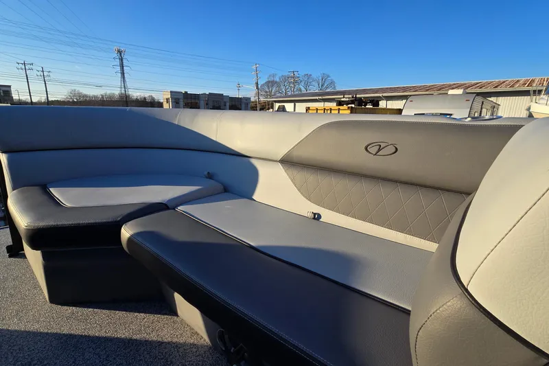Slide: The Image of 2023 Veranda Vista View 20RC boat interior with gray seating and logo detail. - 23