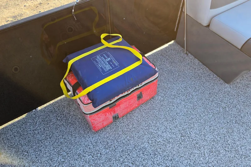 Slide: The Image of Safety equipment on Veranda Vista View 20RC boat, 2023 model, with life jacket and cooler. - 35