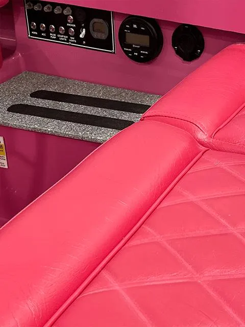 Slide: The Image of 2024 Vision Marine Fantail 217 interior with vibrant pink seating and control panel. - 6