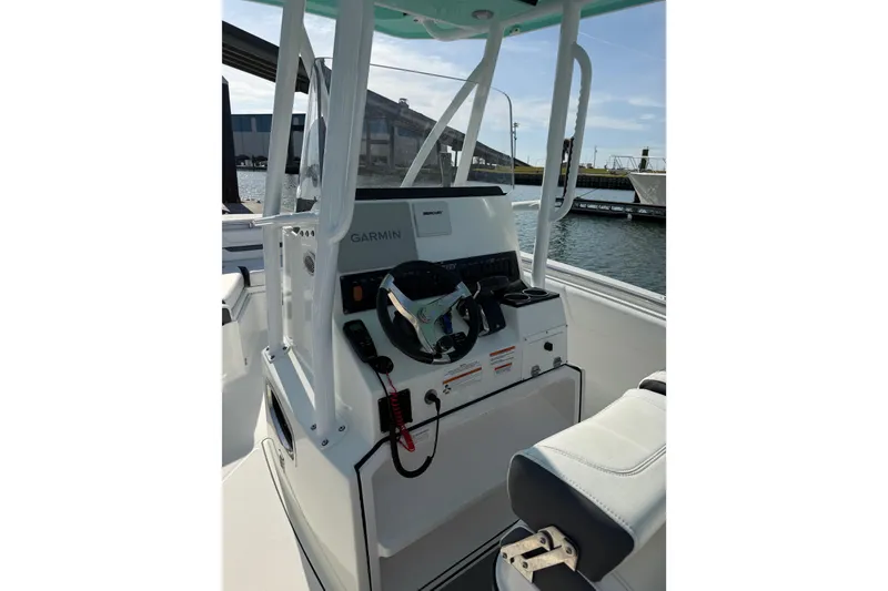 Slide: The Image of 2021 Blackfin 252 CC boat console with Garmin navigation, docked by the water. - 12