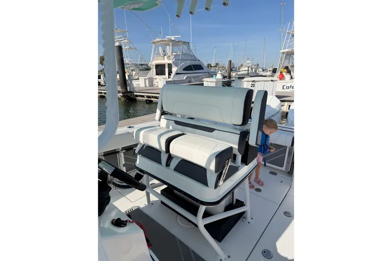 Slide: The Image of 2021 Blackfin 252 CC boat interior with seating at marina dock. - 16
