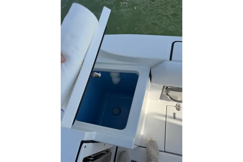 Slide: The Image of Open storage compartment on 2021 Blackfin 252 CC boat, showing interior details. - 17