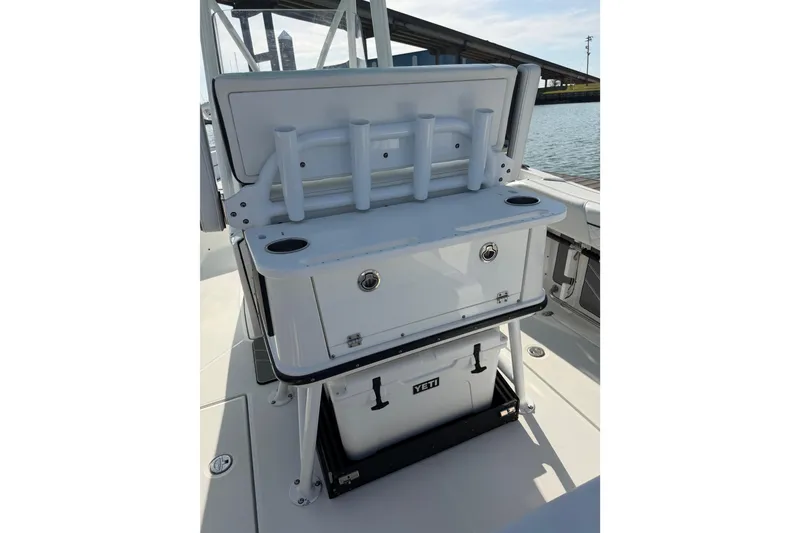 Slide: The Image of 2021 Blackfin 252 CC boat interior with rod holders and YETI cooler. - 18