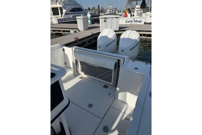 Slide: The Image of 2021 Blackfin 252 CC boat with dual Mercury engines docked at marina. - 19