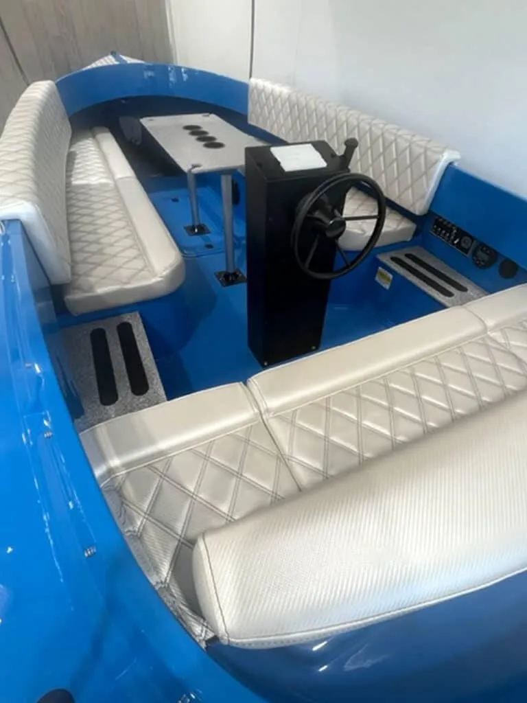 Slide: The Image of 2024 Vision Marine Technologies Fantail 217 interior with blue and white seating. - 1