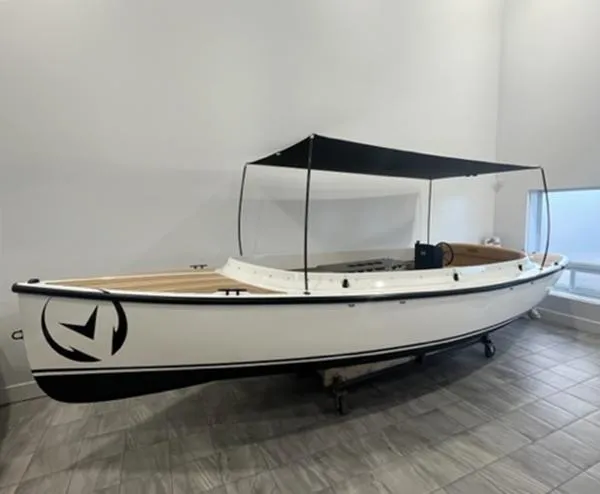 The Image of 2024 Vision Marine Technologies Fantail 217 boat with canopy, displayed indoors. - 0
