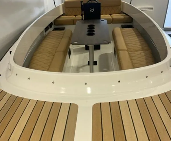 Slide: The Image of 2024 Vision Marine Technologies Fantail 217 boat interior with cushioned seating and central table. - 4